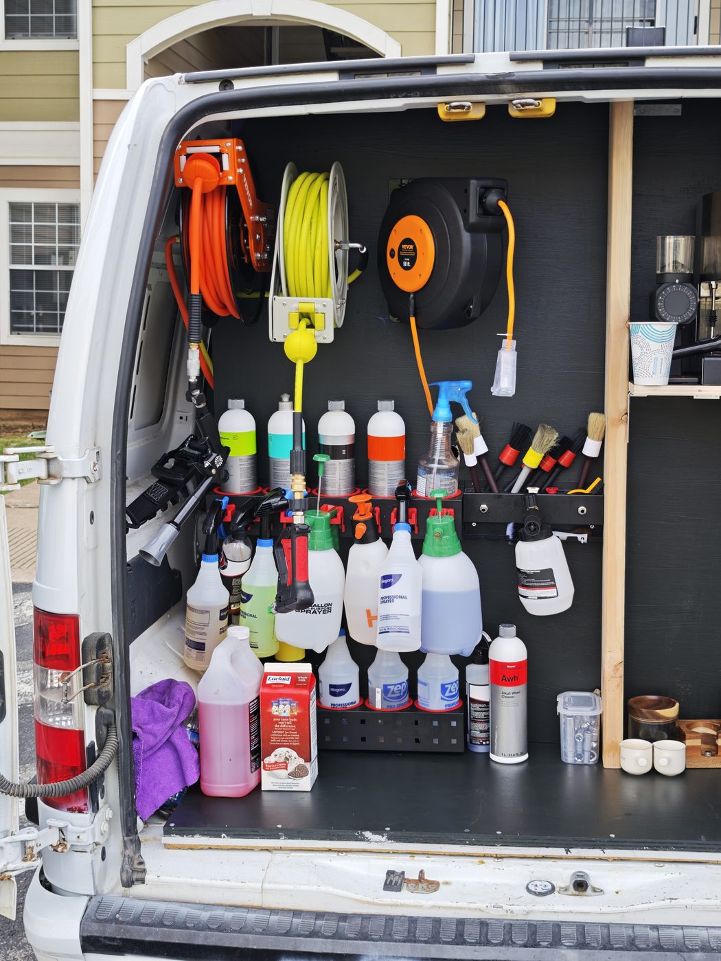 Fully equipped mobile detailing van — hoses, chemicals, brushes and the espresso corner